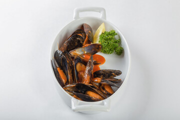 Blue mussels in tomatoes, white background