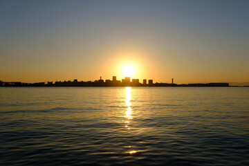 神戸ハーバーランドからの夜明け。太陽の光が波に反射して輝く