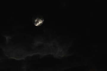 Super moon. An attractive photo of the night sky background with a cloudy and bright full moon. Night sky with a beautiful full moon.