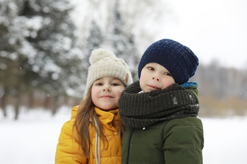 Fototapeta premium Happy family playing and laughing in winter outdoors in the snow. City park winter day.