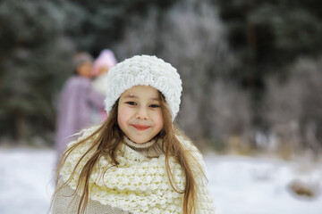 Happy family playing and laughing in winter outdoors in the snow. City park winter day.