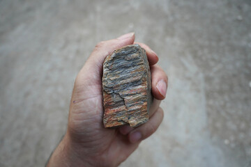  gneiss rock specimen in a hand.