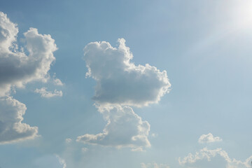 A cloud shaped like a baby dinosaur on blue sky background.