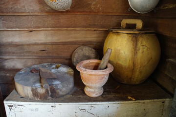 Clay mortar, cutting board and jar as kitchen utensils. Retro Antique or vintage style.