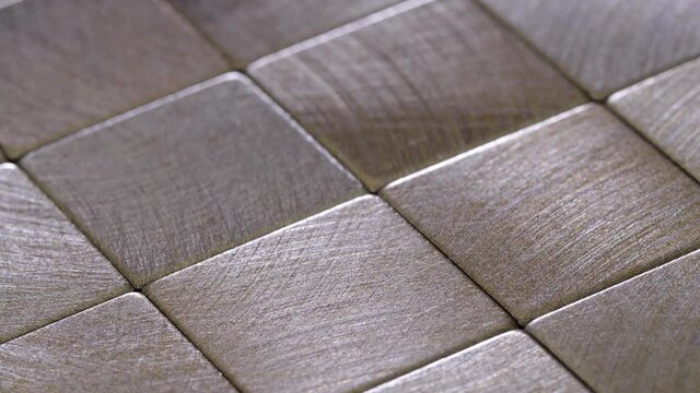 Abstract squares background. Metal surface consisting of square plates. Depth of field.