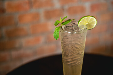 Lemon soda. Beverage for summer with brick wall background.