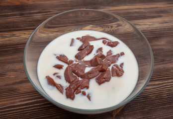 Beef liver soaked in milk in a glass bowl. Recipe
