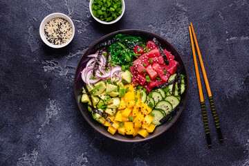 Hawaiian tuna poke bowl with seaweed, avocado, mango, cucumber.