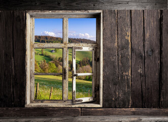 view through a wooden window into the landscape - obrazy, fototapety, plakaty