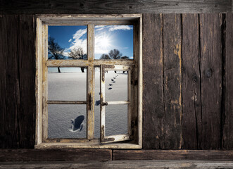 view through a wooden window into the winter Landscape