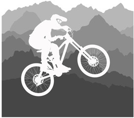 Silhouette of a cyclist jumping on a background of mountains