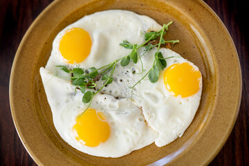 Scrambled eggs for breakfast from three eggs. Fried eggs.