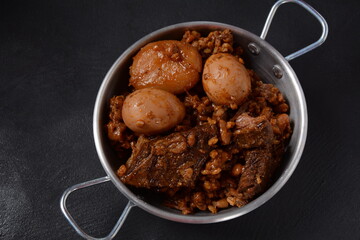 Jewish cuisine - Cholent (Hamin).Traditional main dish for Jewish Shabbat lunch, slow cooked beef Stew with potato, beans, barleys, wheat and brown eggs in a metal casserole