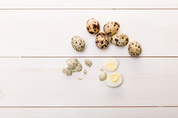 fresh quail eggs on white table