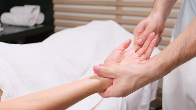 Procedure hands massage in the spa salon.Hand Care in the beauty salon. Massage the fingers and wrist in a spa salon. Spa manicure procedure.