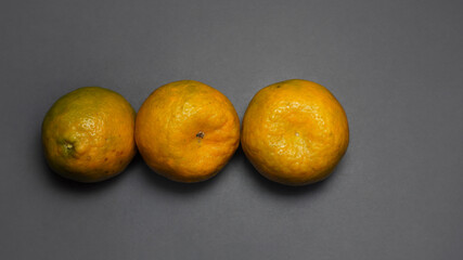 Oranges on a grey background.