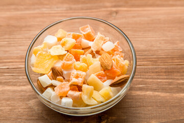 The mixture of nuts and dried fruit in a glass Cup on the table