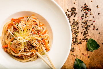 Noodles wok with vegetables and meat in the Thai sauce recipe from the chef