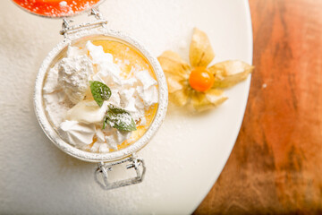 European dessert - honey cake with fresh cream and mint slice