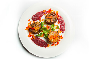 Three rolls of eggplant with slices of carrots and red sauce