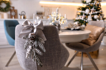 Grey chair with beautiful Christmas decor in kitchen. Interior design