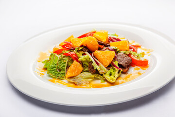 Warm salad from veal, orange and green