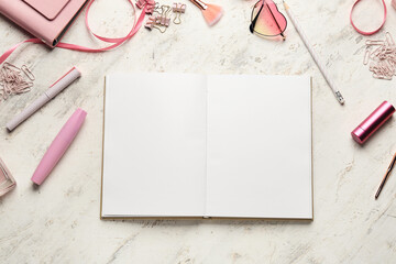 Book with female accessories on white background