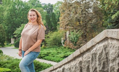 Beautiful woman on a walk in the city. Autumn- Winter time. A nice middle aged plus size woman at the street. Citizen lifestyle