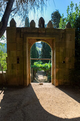 Old arch gate, path and staircase in granite to vineyards and typically Mediterranean, inside the gardens at the Solar de Mateus