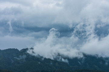 landscape with rain and rising clouds of fog