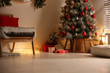 Beautiful decorated Christmas tree in festive room interior