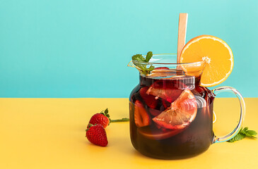 Summer cold cocktail, fruit and berry red wine sangria with apple, lemon, oranges and strawberry