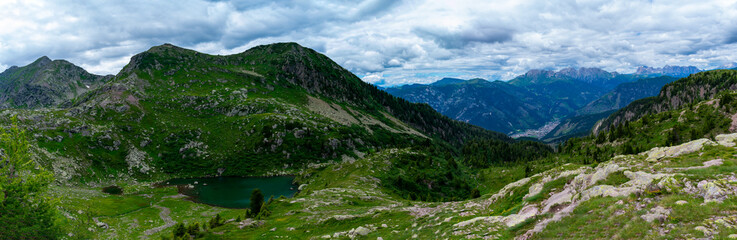 Fototapeta na wymiar Italy, Trentino, Predazzo, Lagorai, Lago delle Trote - 19 July 2020 - Panoramic view of Latemar and a glimpse of the Lagorai