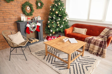 Interior of living room with fireplace decorated for Christmas