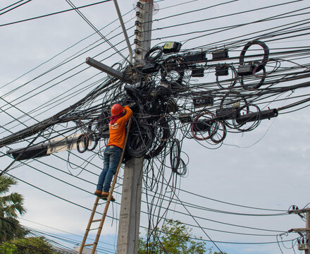 a Thai electrician at his daily job