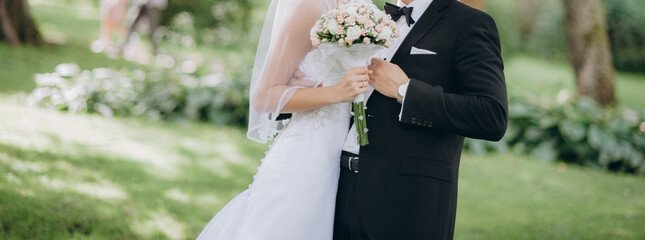 Wedding couple walking together holding hands in the park. Wedding agency concept.