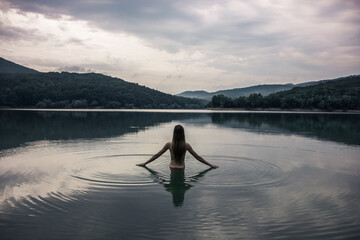 Fototapeta na wymiar Swimming in the lake. Departure for nature. Young girls