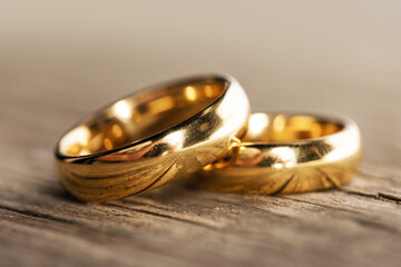 Golden wedding rings on wood