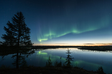 Northern lights reflected in the water