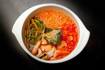 Japanese soup with spicy sauce and seafood