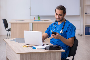 Young male doctor working in the clinic