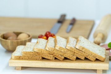 Slice of Whole wheat bread on a wooden plate in the kitchen