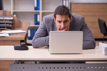 Young male employee working in the office