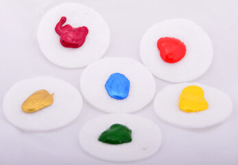 Red, orange, green, yellow, blue colored oil paint on circle cottons.