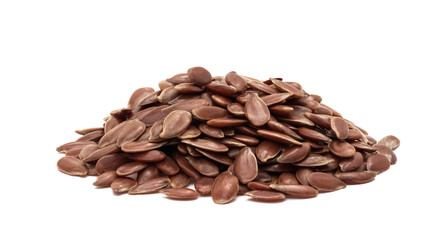 Close up of small pile of linseed or flax seed seen fron the side and isolated on white with shadows