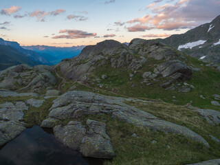 Evening sunset summer view of Stubai valley from Bremer Hutte at hiking trail, Stubai Hohenweg, rock, boulders and moutain peaks. Tyrol Alps, Austria