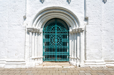 Fototapeta na wymiar Old cathedral forged metal gate with door knobs