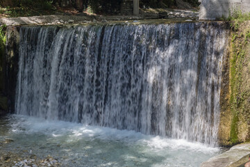 Waterfall in the forest on a sunny summer day