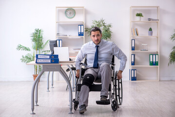 Young leg injured employee working in the office