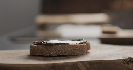 chocolate hazelnut spread on ciabatta slice on wood board